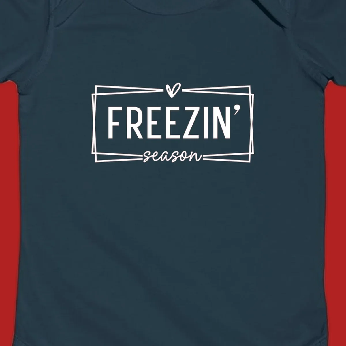 Freezin' Season text design with heart icon and border, for winter holidays.