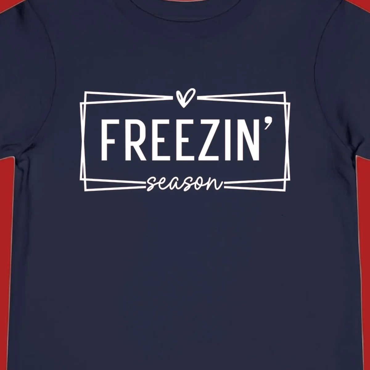 Freezin' Season text design with heart icon and border, for winter holidays.