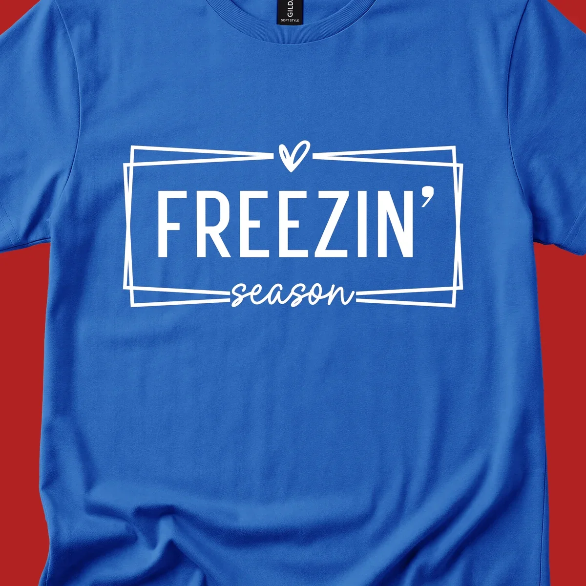 Freezin' Season text design with heart icon and border, for winter holidays.
