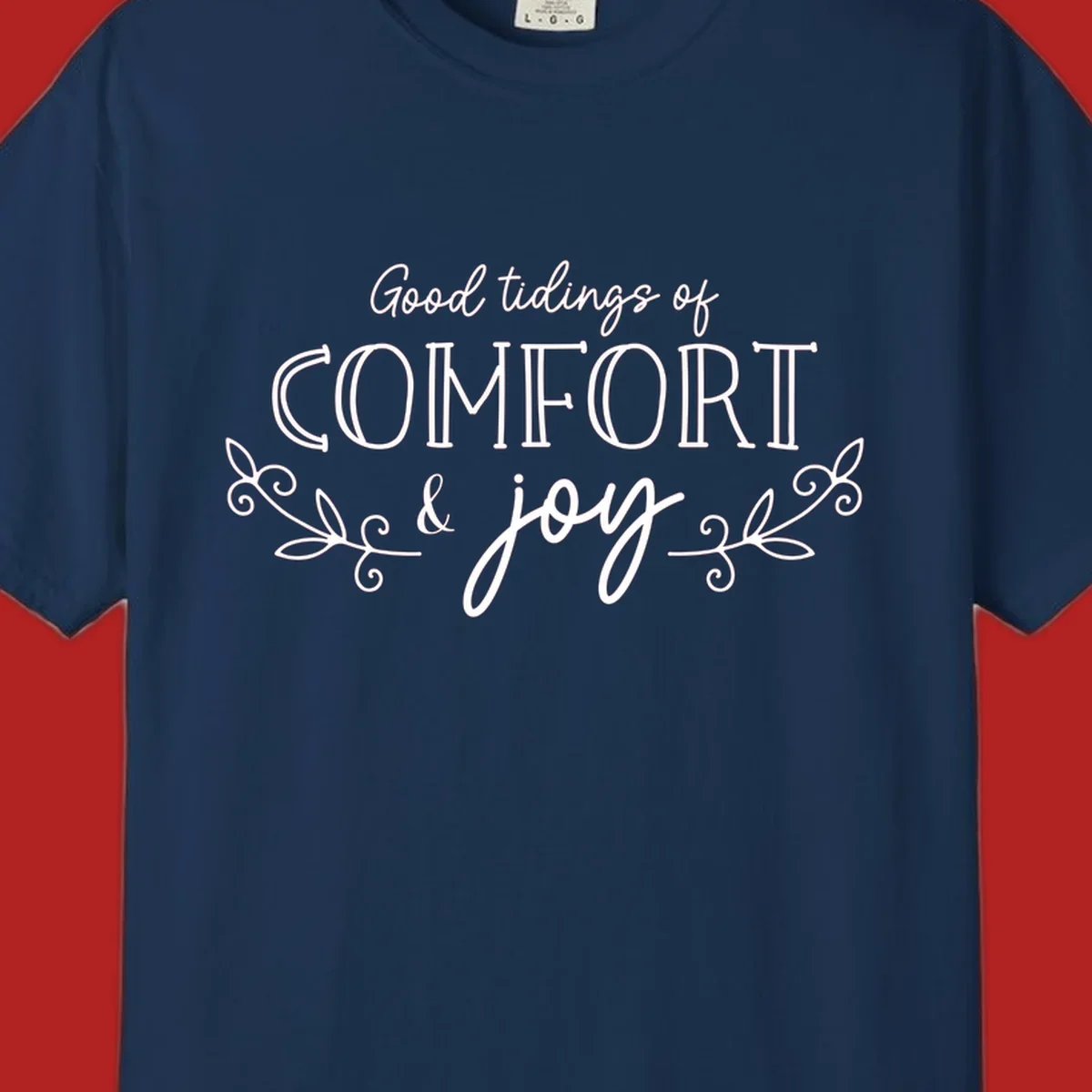 Good tidings of comfort and joy holiday text design with floral accents.