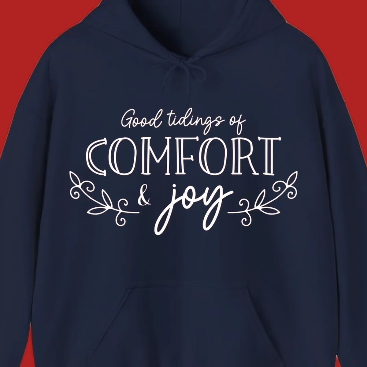 Good tidings of comfort and joy holiday text design with floral accents.