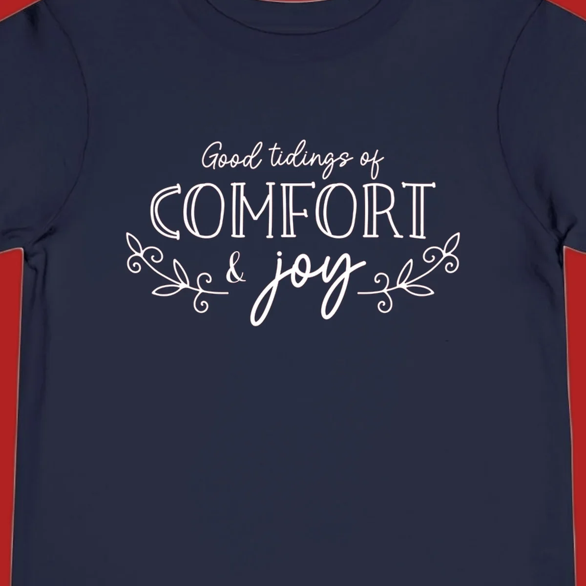 Good tidings of comfort and joy holiday text design with floral accents.