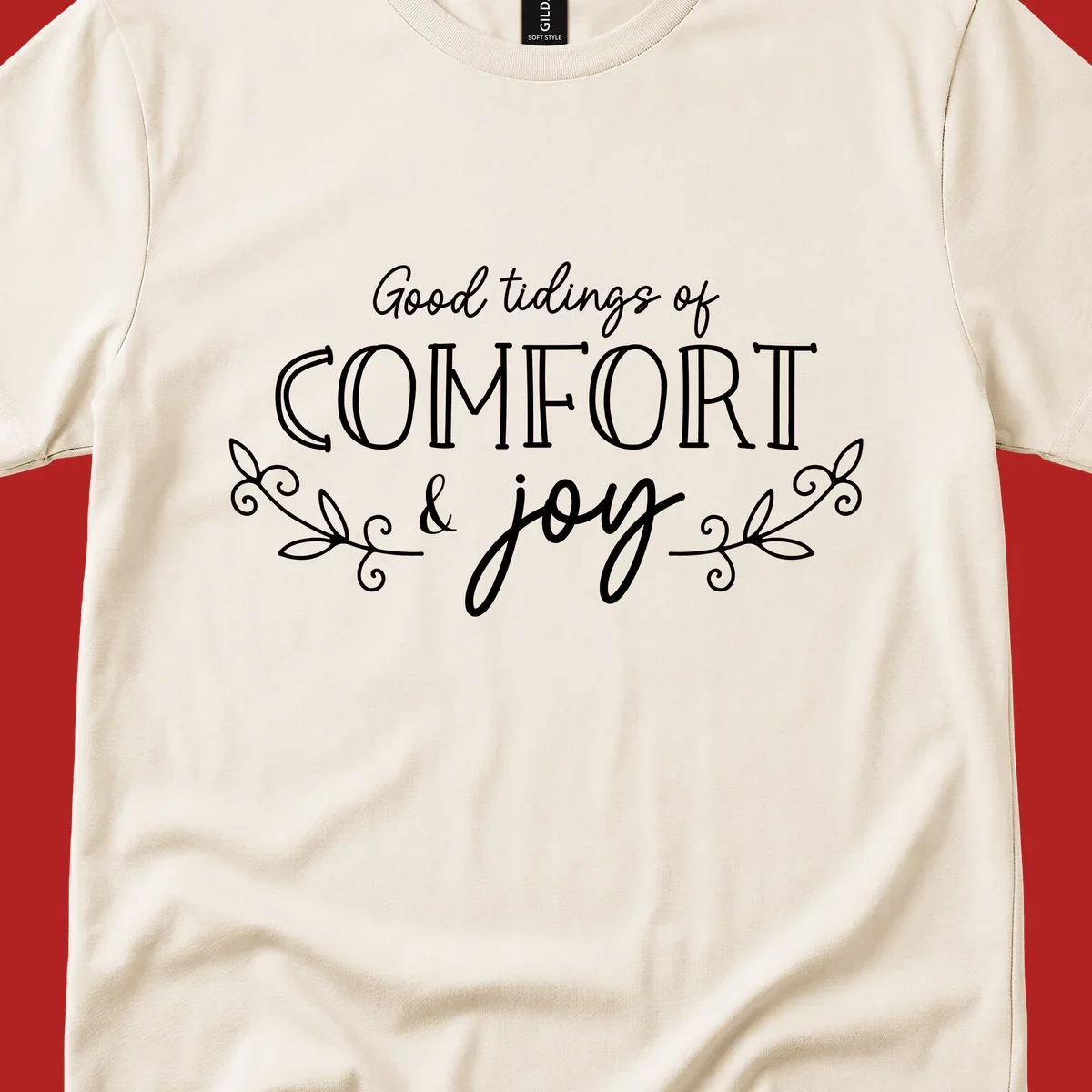 Good tidings of comfort and joy holiday text design with floral accents.