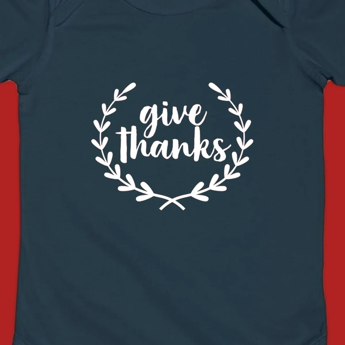 Give thanks script text inside a laurel wreath.