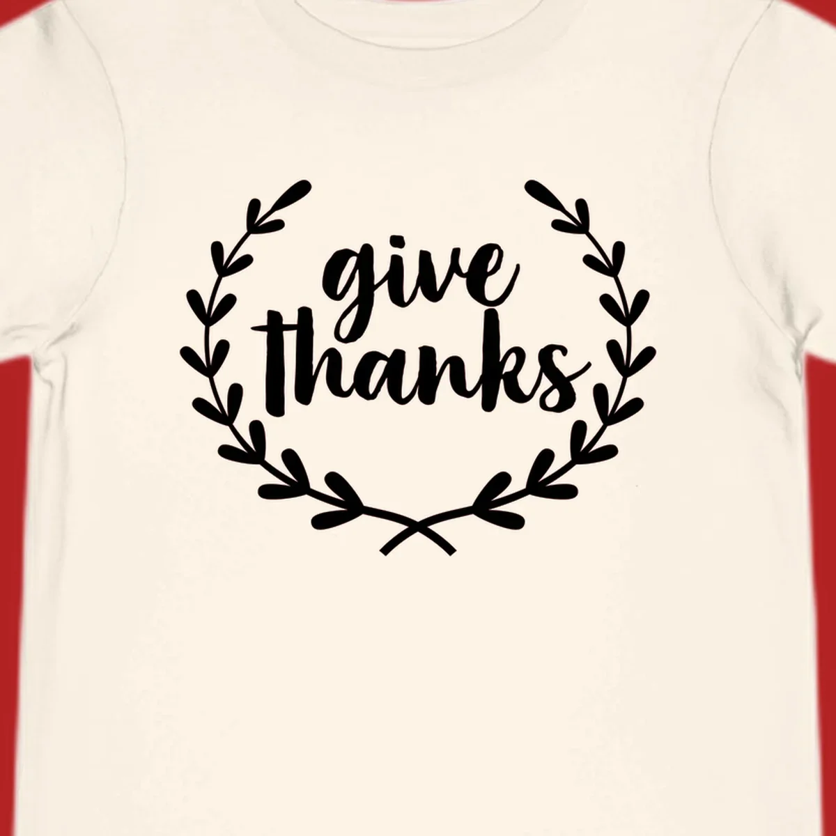 Give thanks script text inside a laurel wreath.