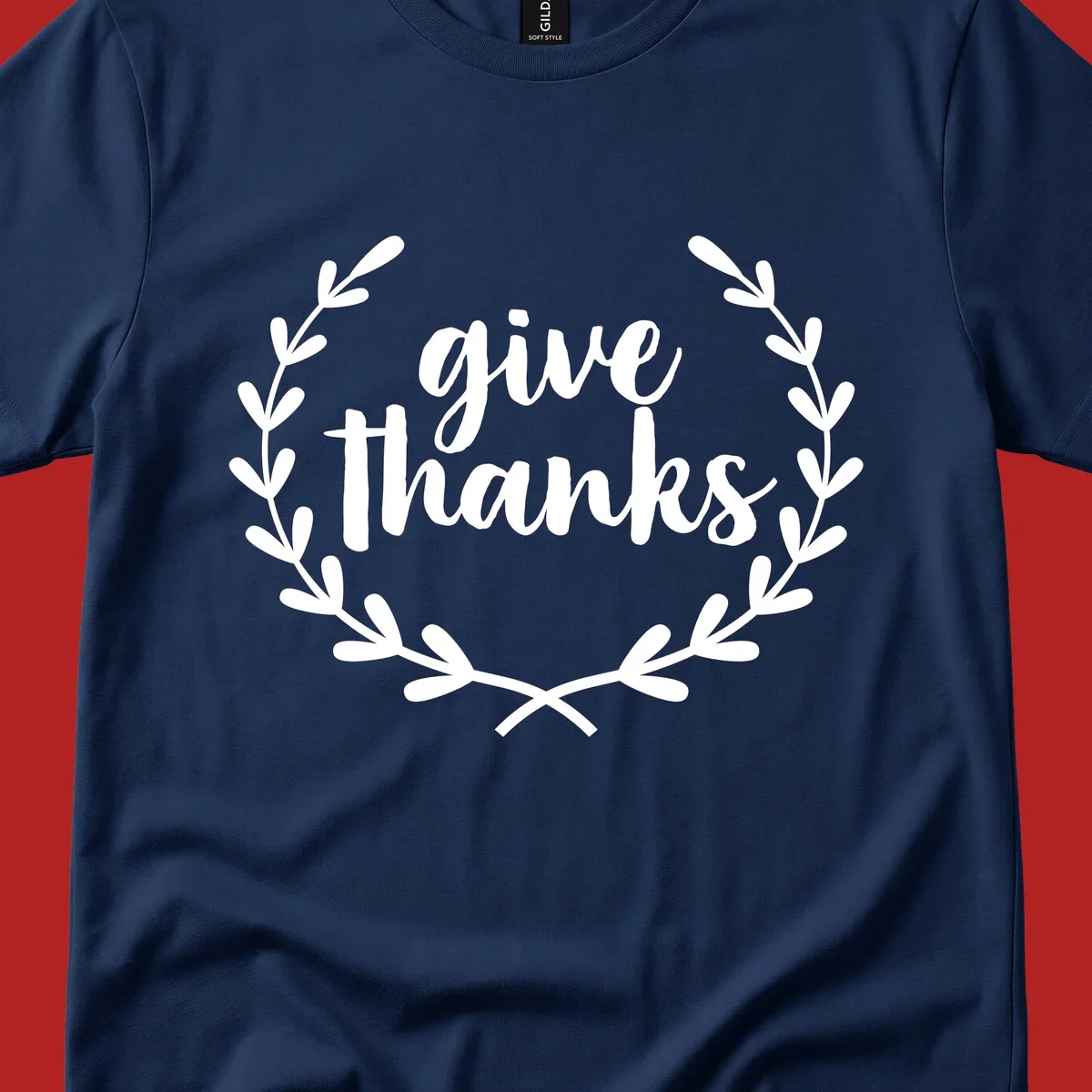 Give thanks script text inside a laurel wreath.