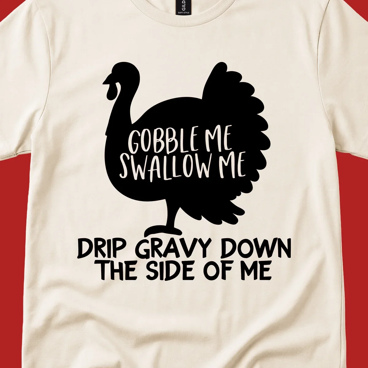Thanksgiving turkey design with text, featuring a silhouette and the phrase 'Gobble Me Swallow Me Drip Gravy Down The Side Of Me'.