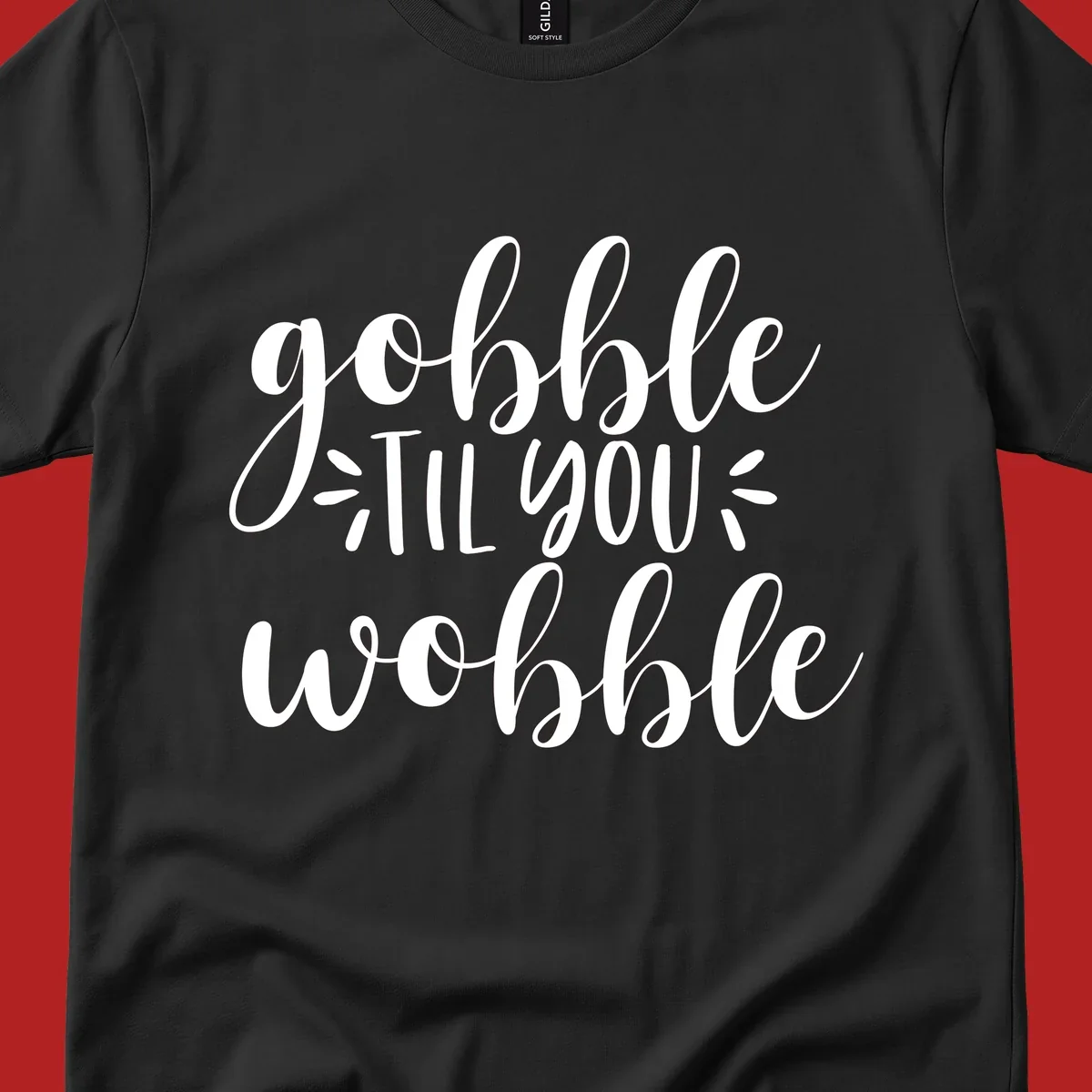 Gobble 'til you wobble thanksgiving phrase in white script font.