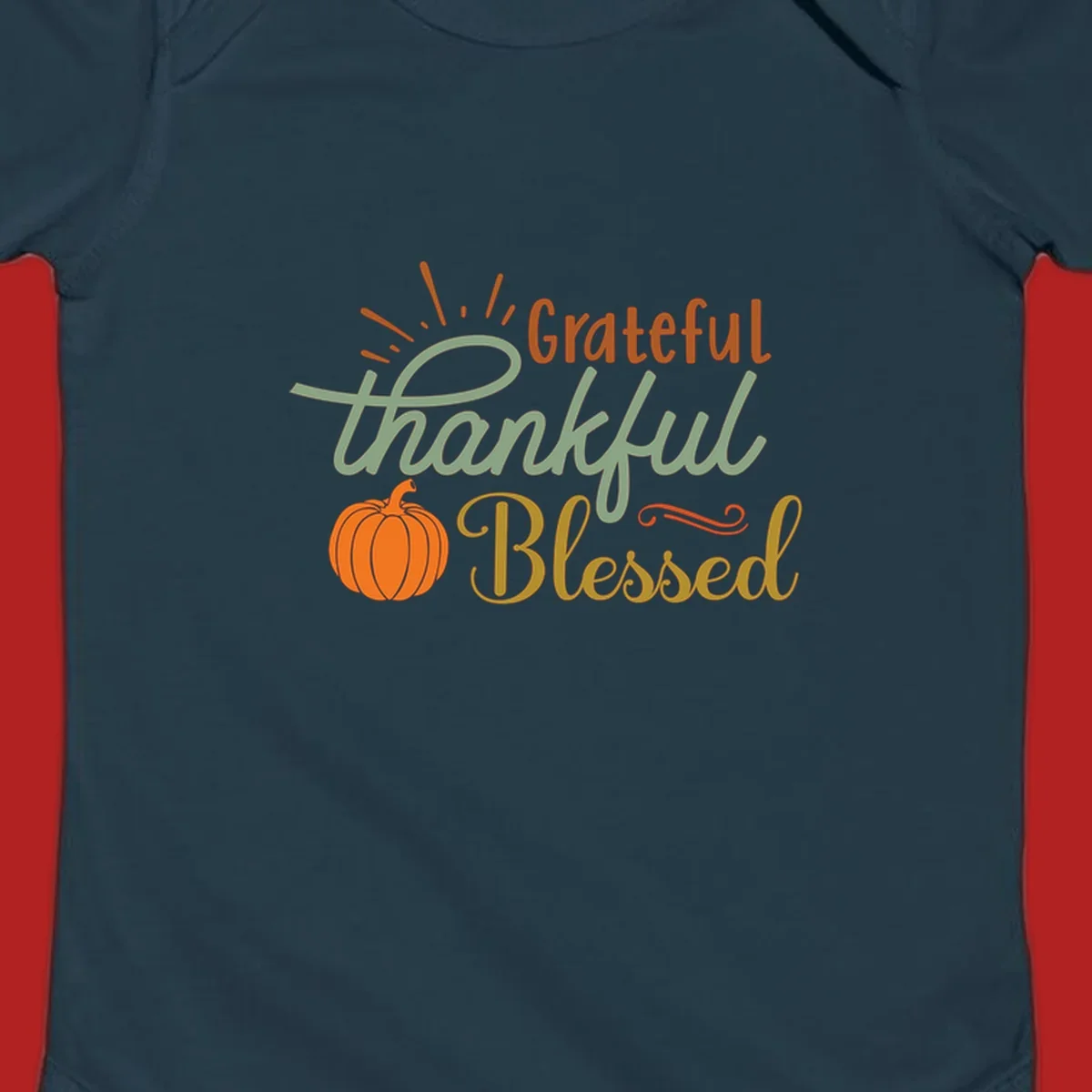 Grateful thankful blessed text with pumpkin and sun rays, autumn holiday design.