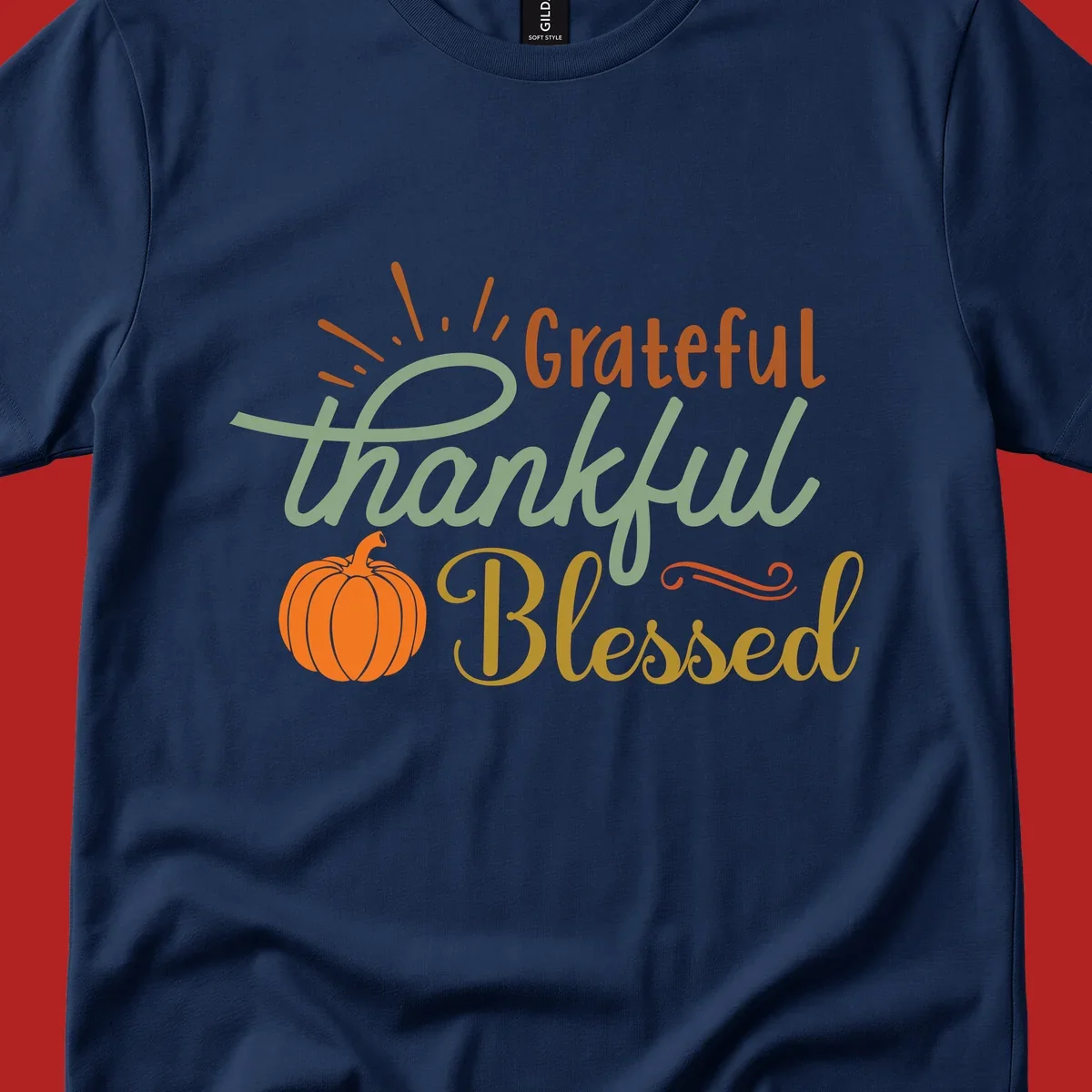 Grateful thankful blessed text with pumpkin and sun rays, autumn holiday design.
