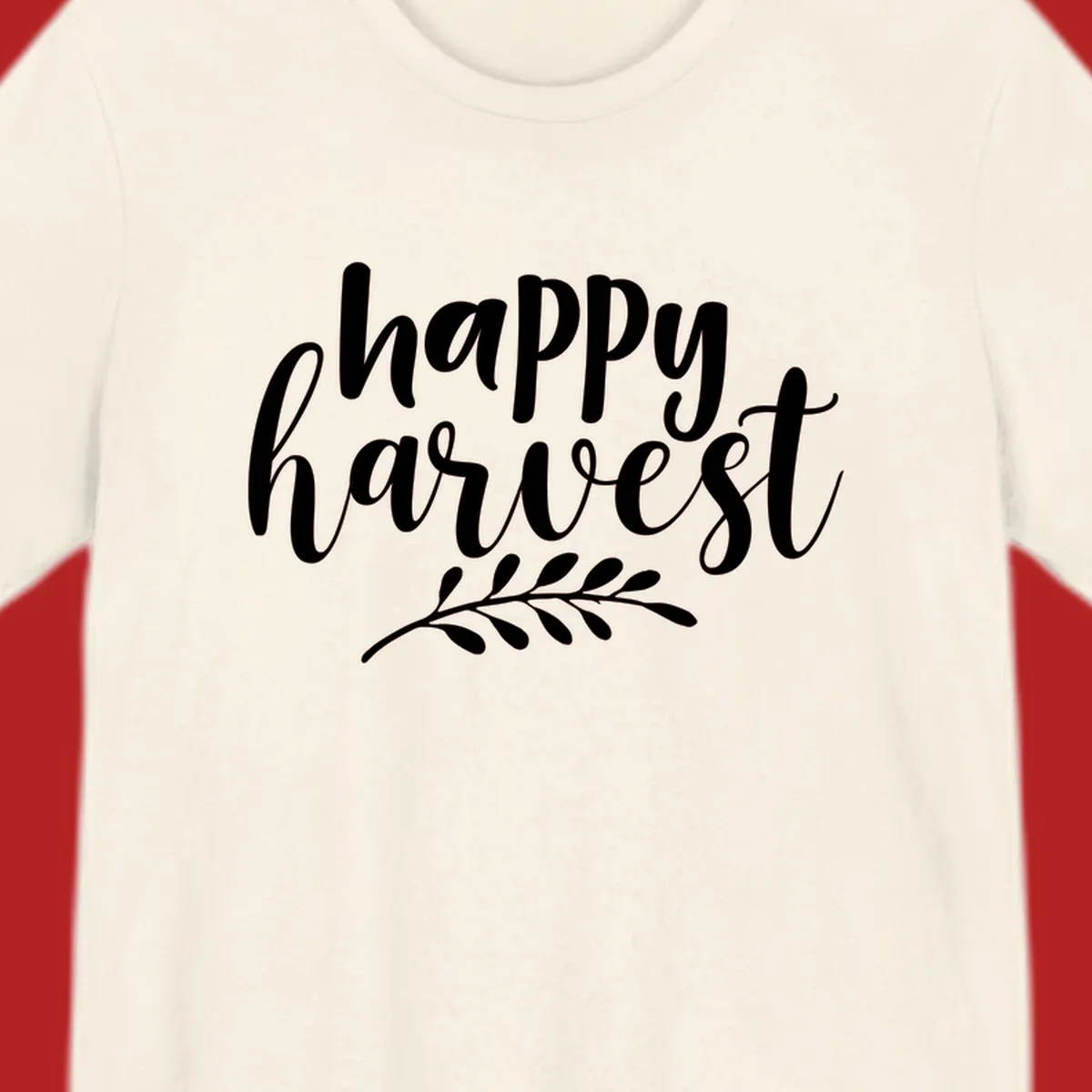 Happy harvest script text with a leaf sprig, suitable for fall and Thanksgiving.