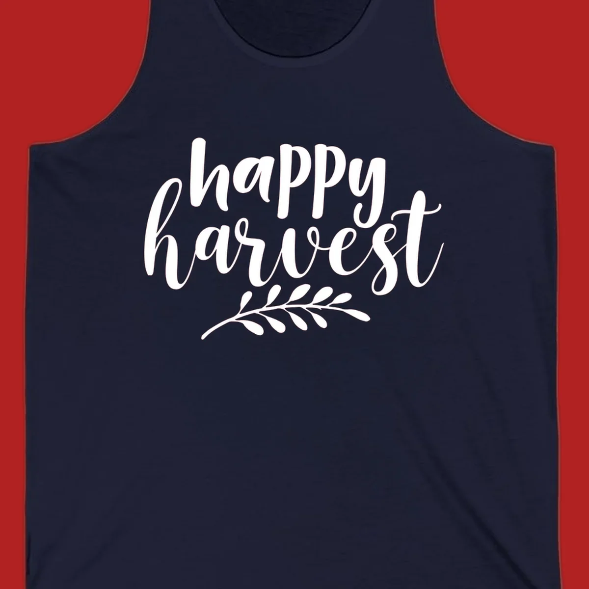 Happy harvest script text with a leaf sprig, suitable for fall and Thanksgiving.