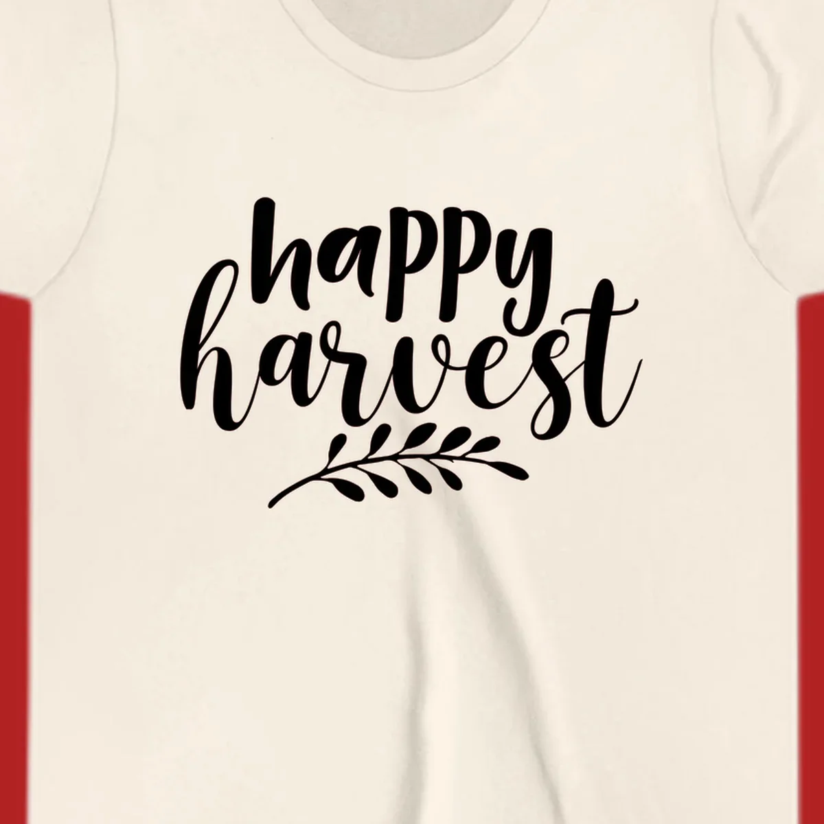 Happy harvest script text with a leaf sprig, suitable for fall and Thanksgiving.