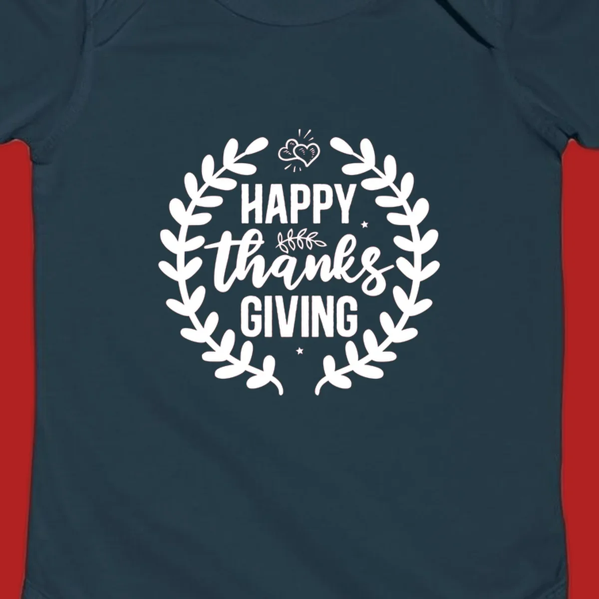 Happy Thanksgiving lettering inside a laurel wreath with hearts and stars.