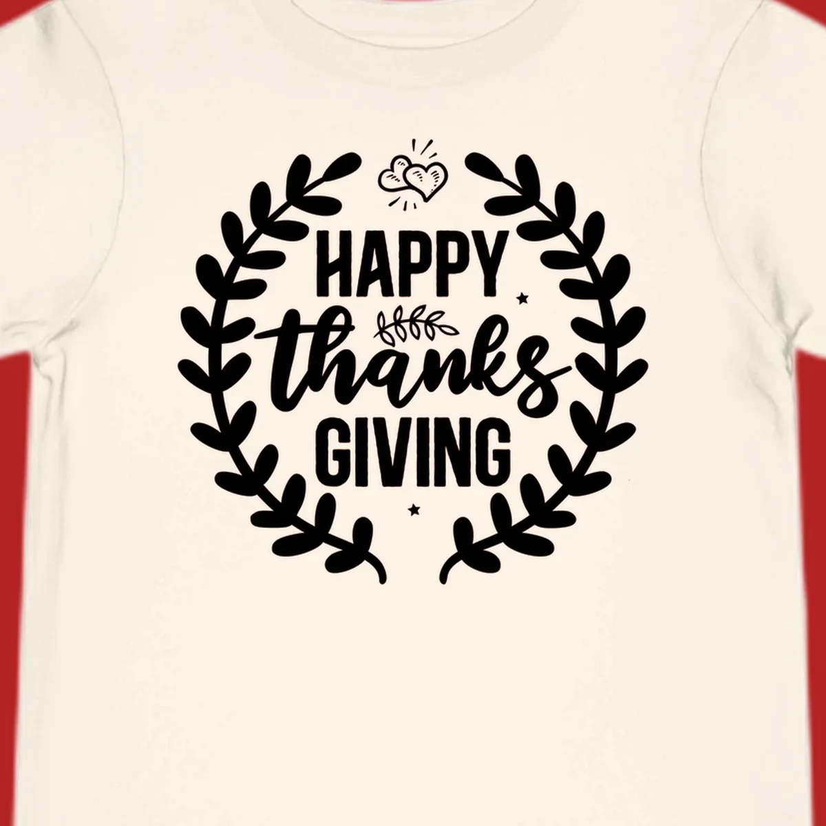Happy Thanksgiving lettering inside a laurel wreath with hearts and stars.