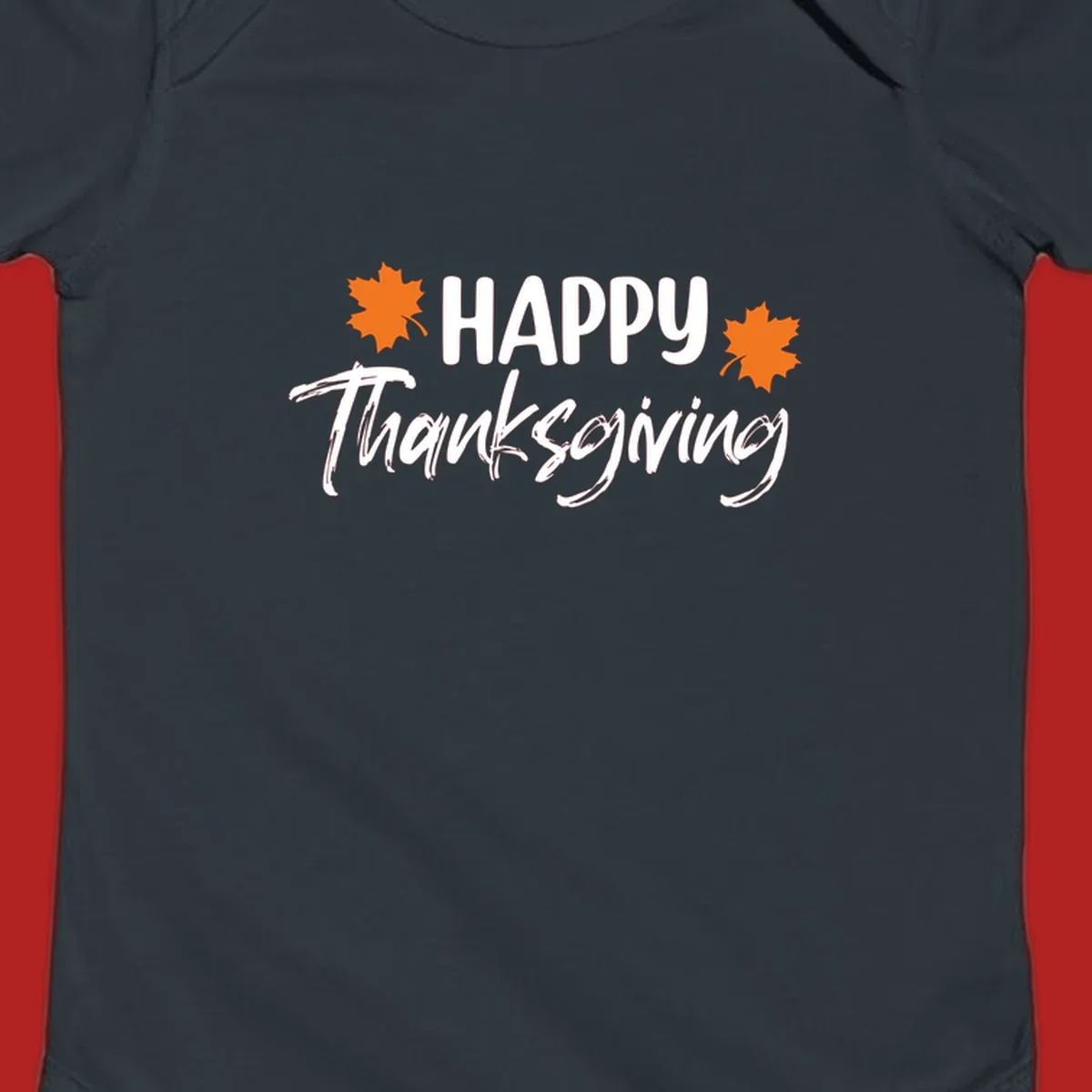 Happy Thanksgiving text with orange maple leaves, holiday design.