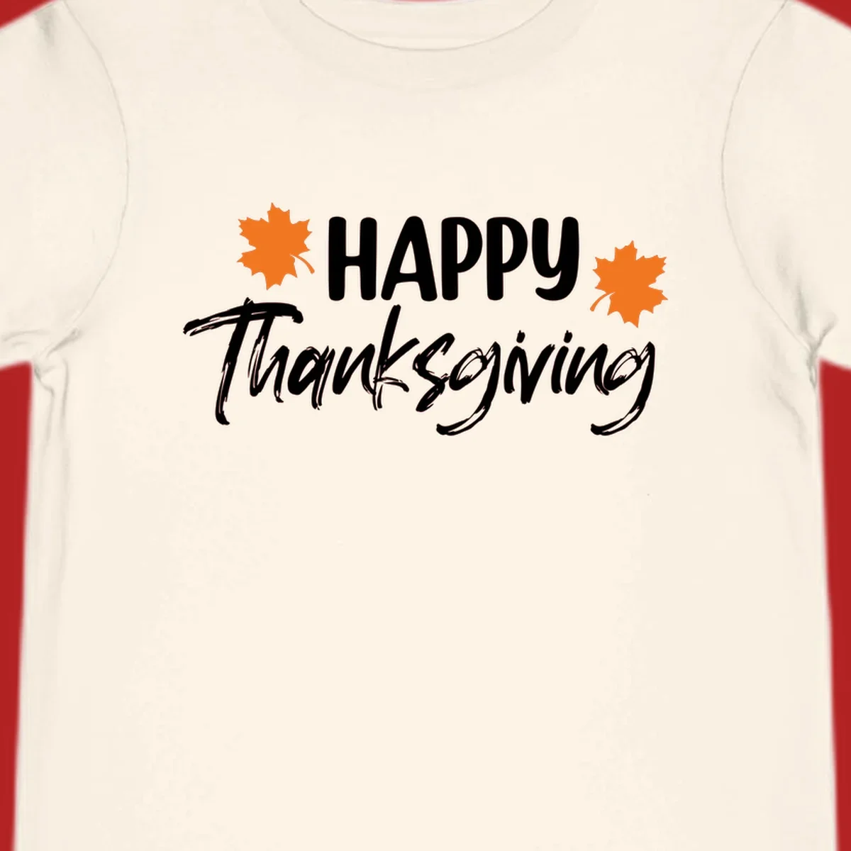 Happy Thanksgiving text with orange maple leaves, holiday design.
