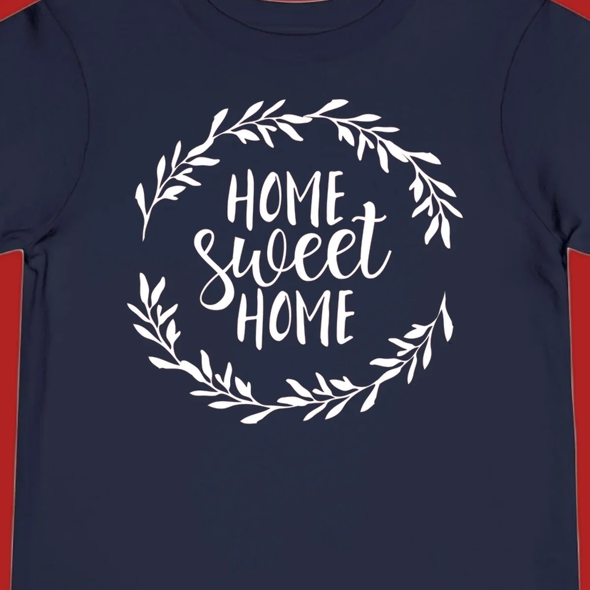 White 'Home Sweet Home' text with a floral wreath on a dark background.