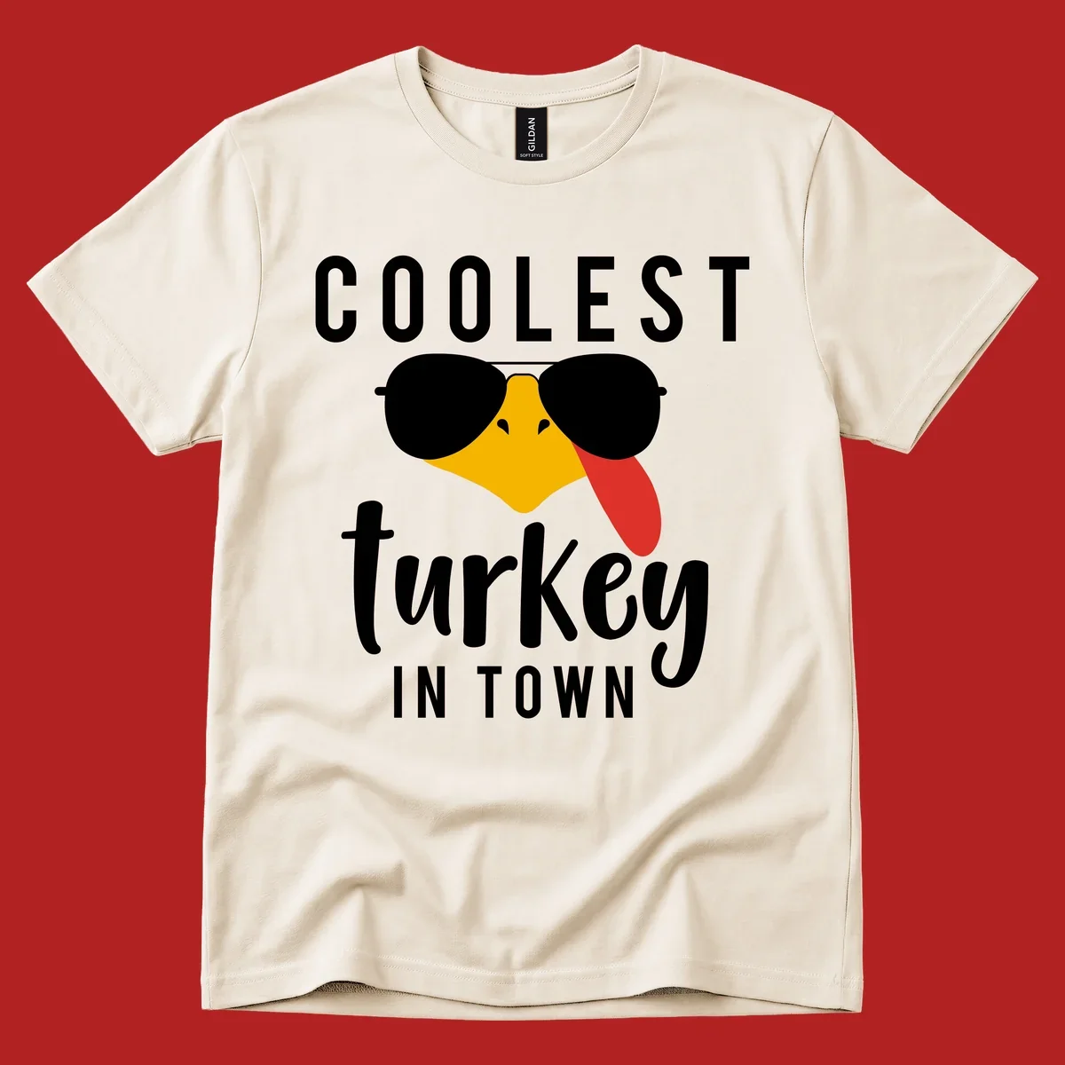 Coolest Turkey In Town Thanksgiving design with a cartoon turkey wearing sunglasses and sticking its tongue out.
