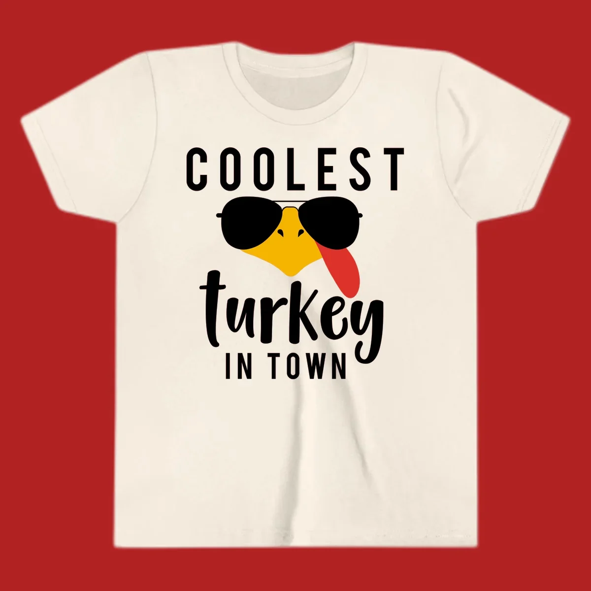 Coolest Turkey In Town Thanksgiving design with a cartoon turkey wearing sunglasses and sticking its tongue out.