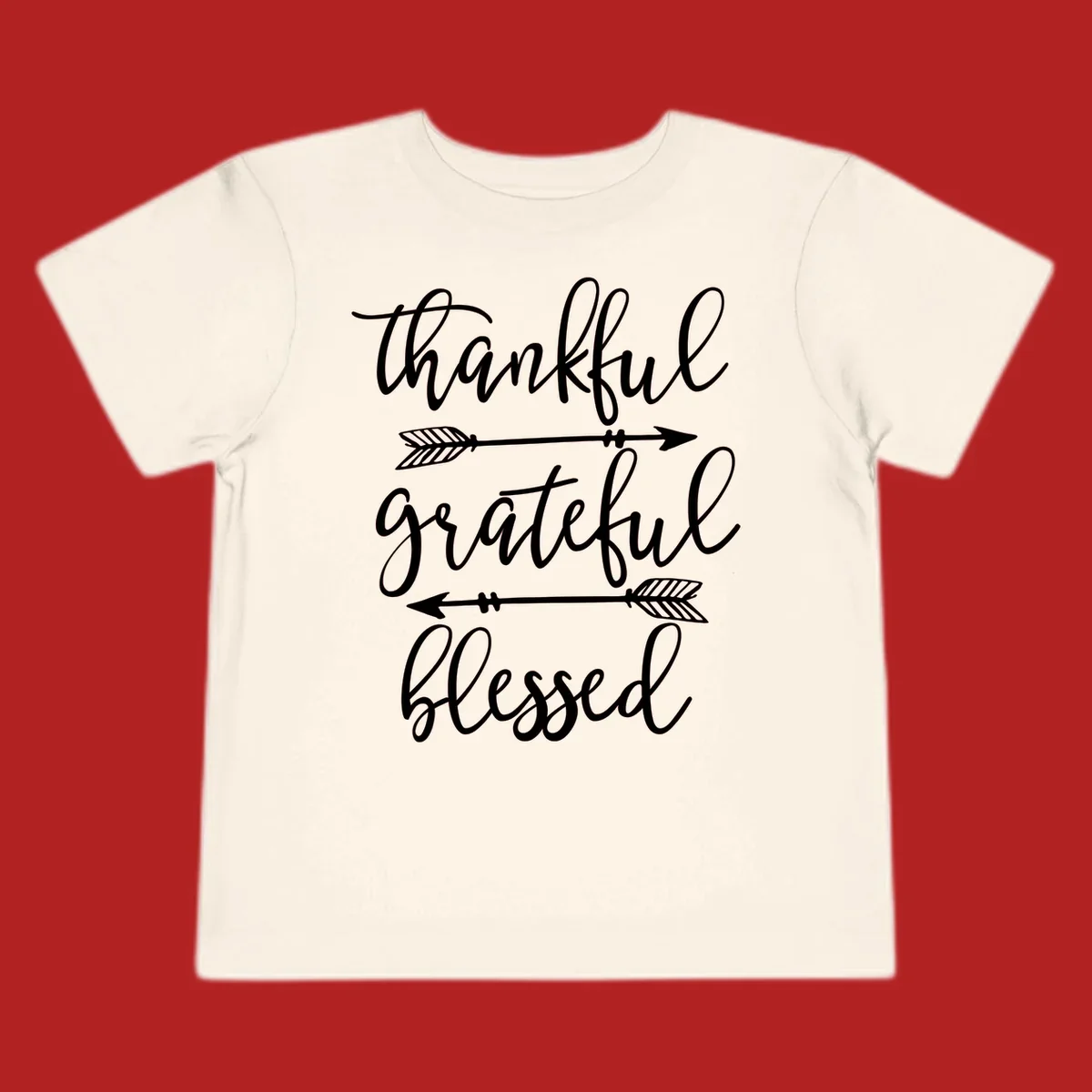 Thankful grateful blessed typography design with arrows on black and white backgrounds.