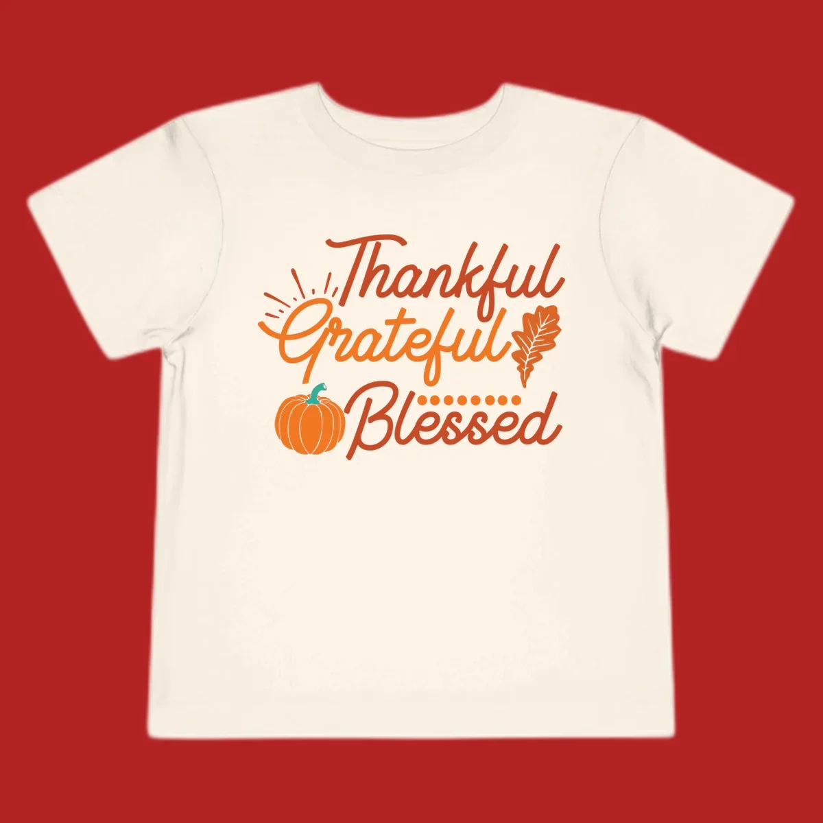 Thankful Grateful Blessed Thanksgiving design with pumpkin and oak leaf.