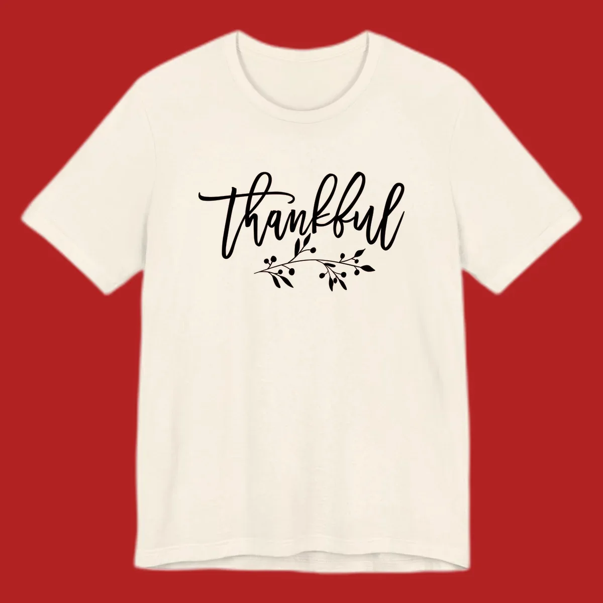 Elegant script text 'Thankful' with a small botanical branch accent, on a plain background.