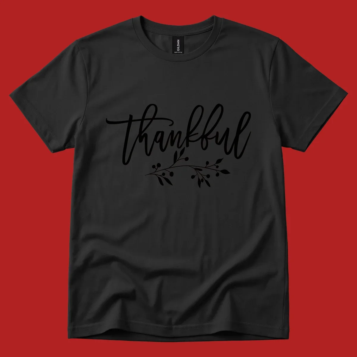 Elegant script text 'Thankful' with a small botanical branch accent, on a plain background.