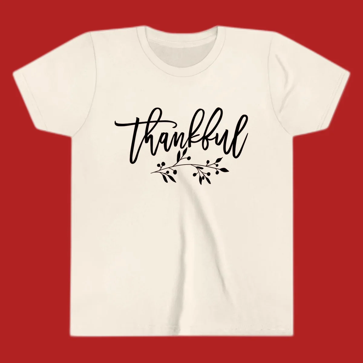 Elegant script text 'Thankful' with a small botanical branch accent, on a plain background.