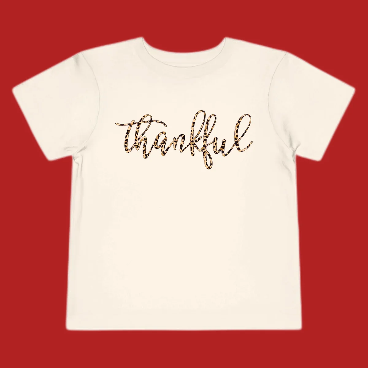 Thankful text in leopard print with a white outline.