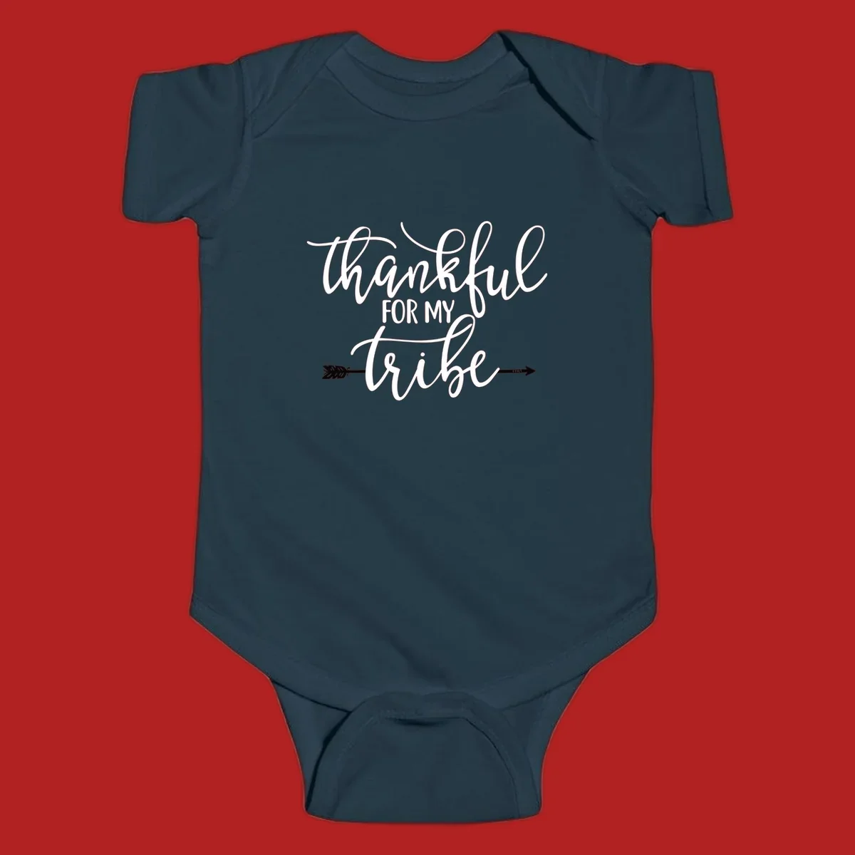 Thankful for my tribe typography design with arrow graphic on black background.