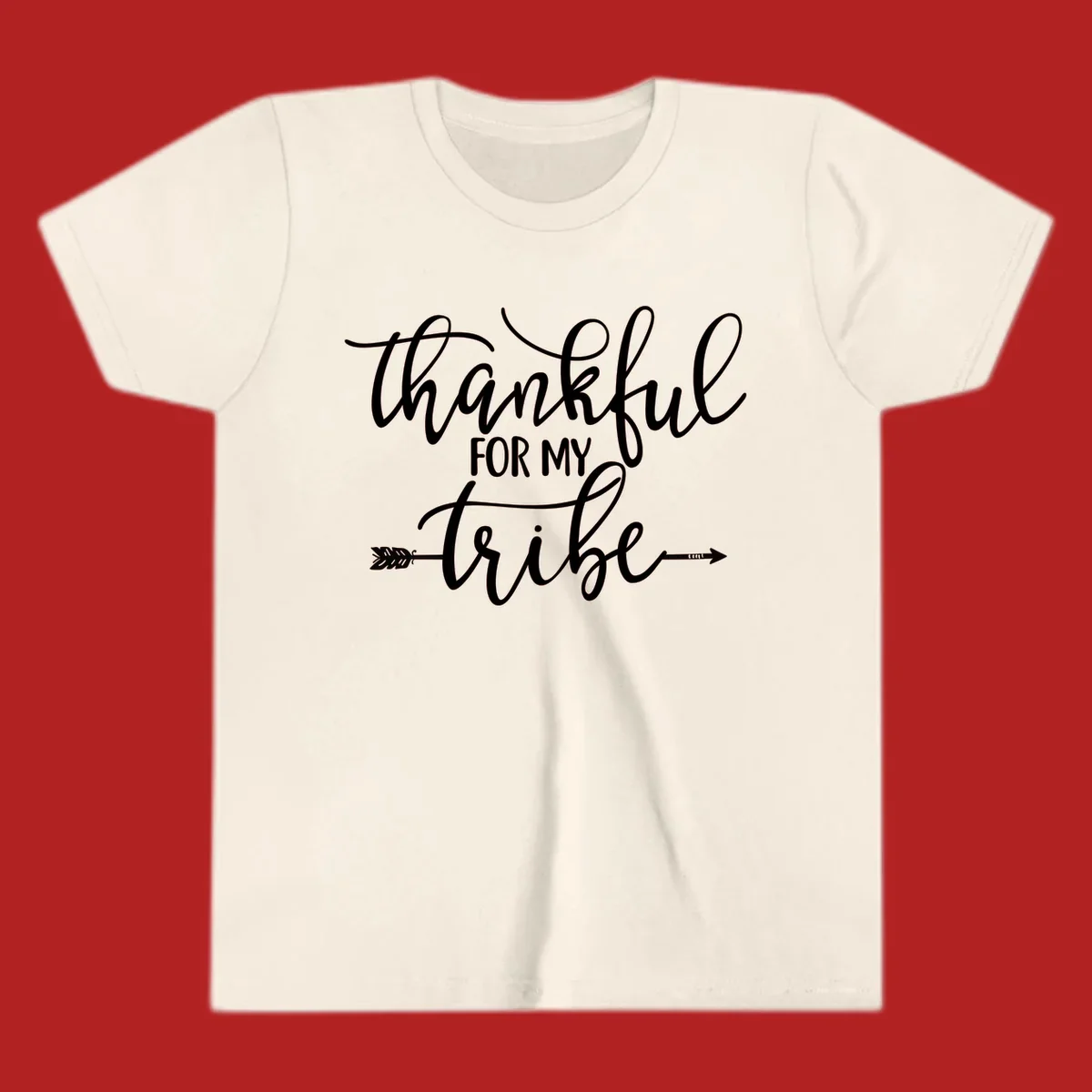 Thankful for my tribe typography design with arrow graphic on black background.
