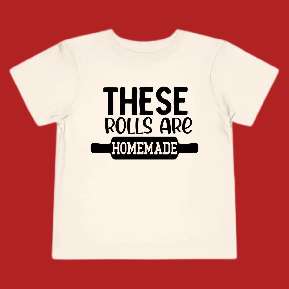 White text 'THESE ROLLS ARE HOMEMADE' with a rolling pin illustration, for homemade rolls baking concept.