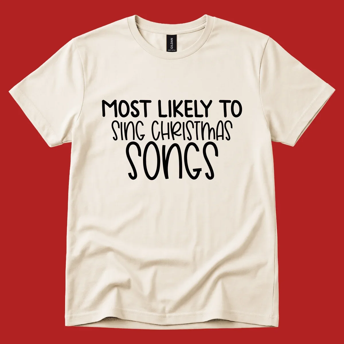 Text design 'Most Likely To Sing Christmas Songs' in white, bold lettering.