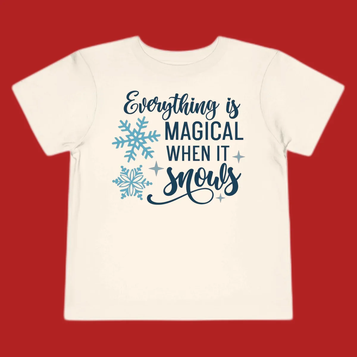 Everything is Magical When It Snows typography with snowflakes and stars.