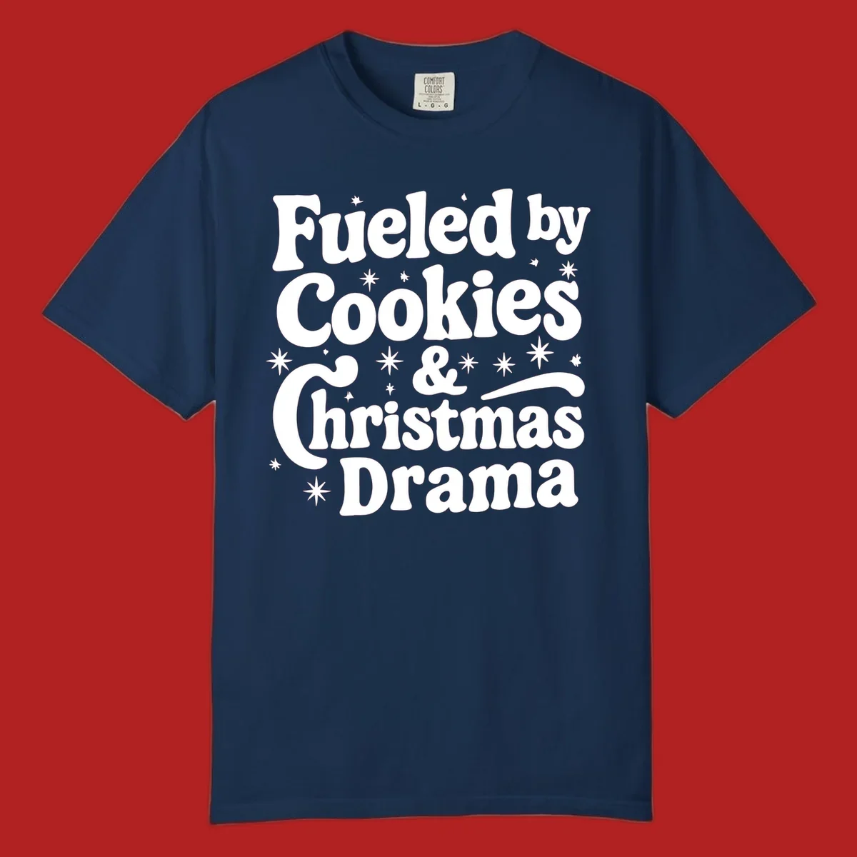 Text design 'Fueled by Cookies & Christmas Drama' with stars, for Christmas.