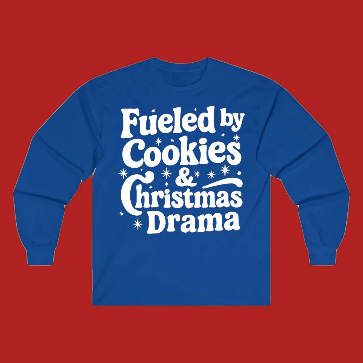 Text design 'Fueled by Cookies & Christmas Drama' with stars, for Christmas.