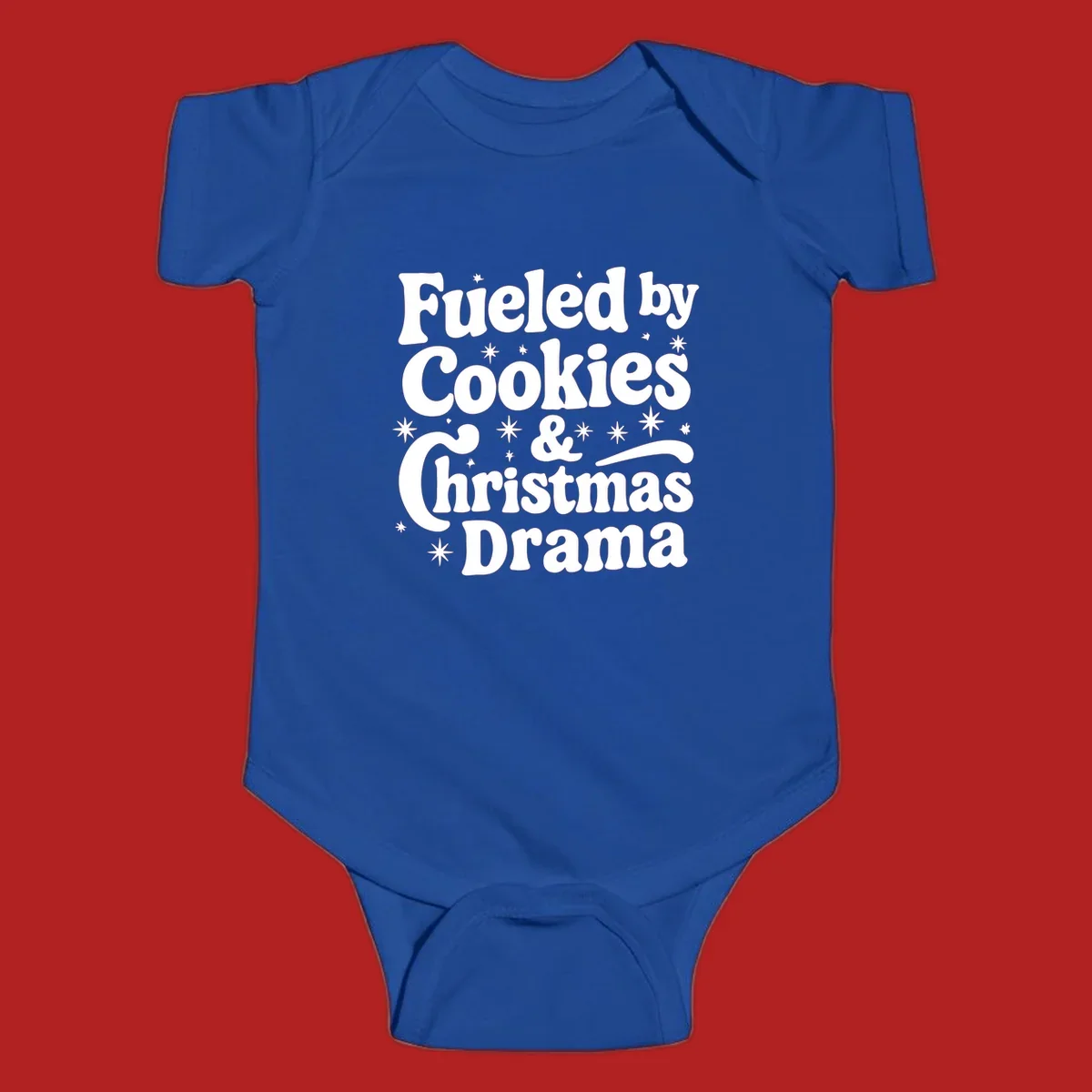 Text design 'Fueled by Cookies & Christmas Drama' with stars, for Christmas.