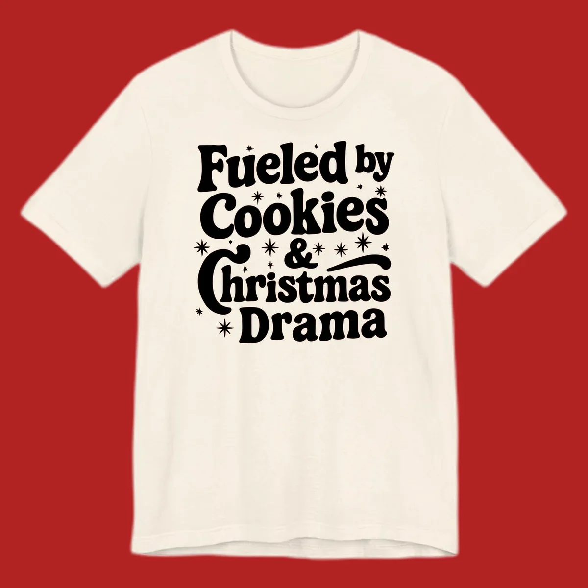 Text design 'Fueled by Cookies & Christmas Drama' with stars, for Christmas.