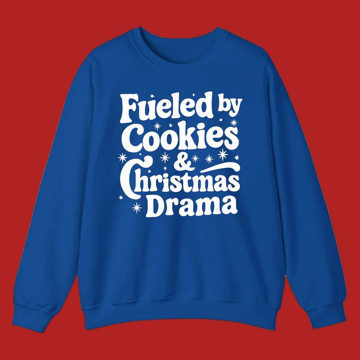 Text design 'Fueled by Cookies & Christmas Drama' with stars, for Christmas.