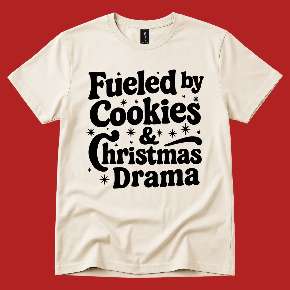 Text design 'Fueled by Cookies & Christmas Drama' with stars, for Christmas.
