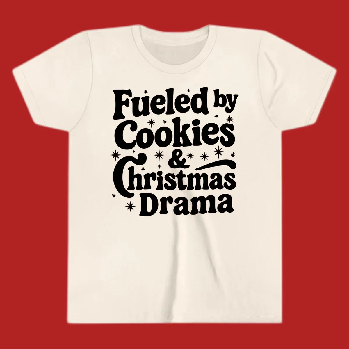 Text design 'Fueled by Cookies & Christmas Drama' with stars, for Christmas.