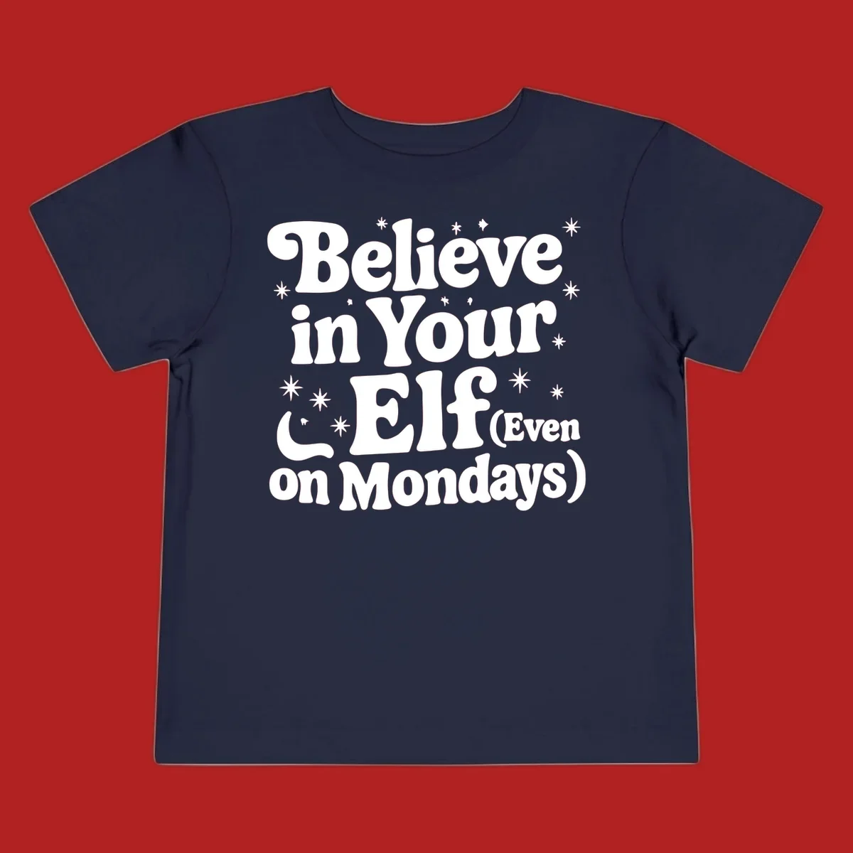 Believe in Your Elf text with stars and sparkles, retro font.