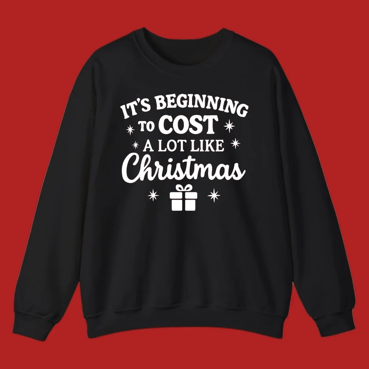 Typography design that says "It's Beginning To Cost A Lot Like Christmas" with stars and a gift box.