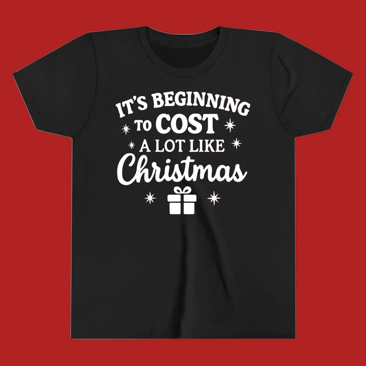 Typography design that says "It's Beginning To Cost A Lot Like Christmas" with stars and a gift box.
