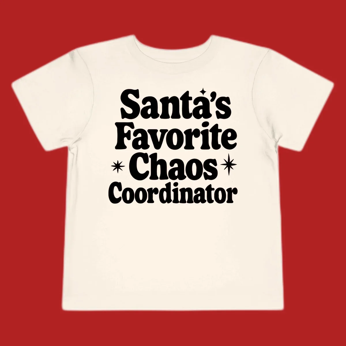 White retro typography reads 'Santa's Favorite Chaos Coordinator' with star accents.