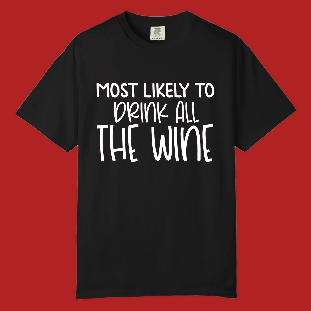 Text design 'MOST LIKELY TO DRINK ALL THE WINE' in white lettering.