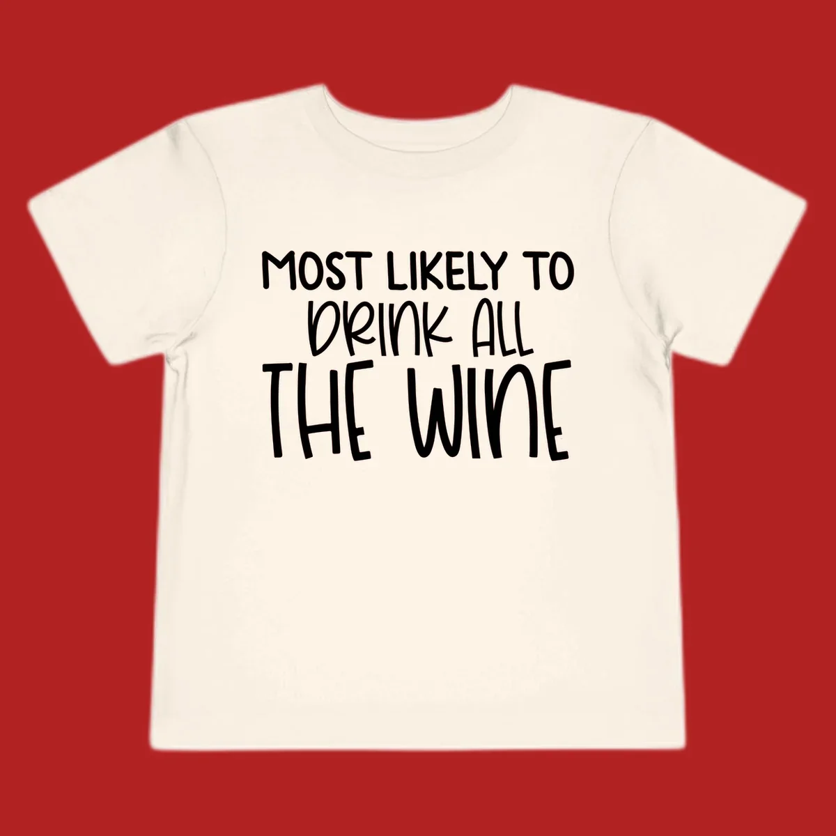 Text design 'MOST LIKELY TO DRINK ALL THE WINE' in white lettering.