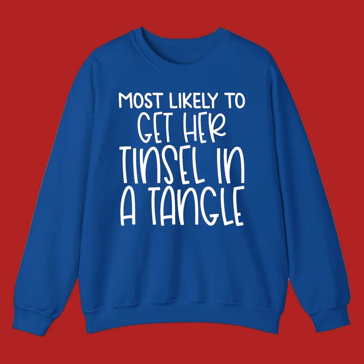 White text 'Most Likely To Get Her Tinsel In A Tangle' on a black background, holiday phrase.