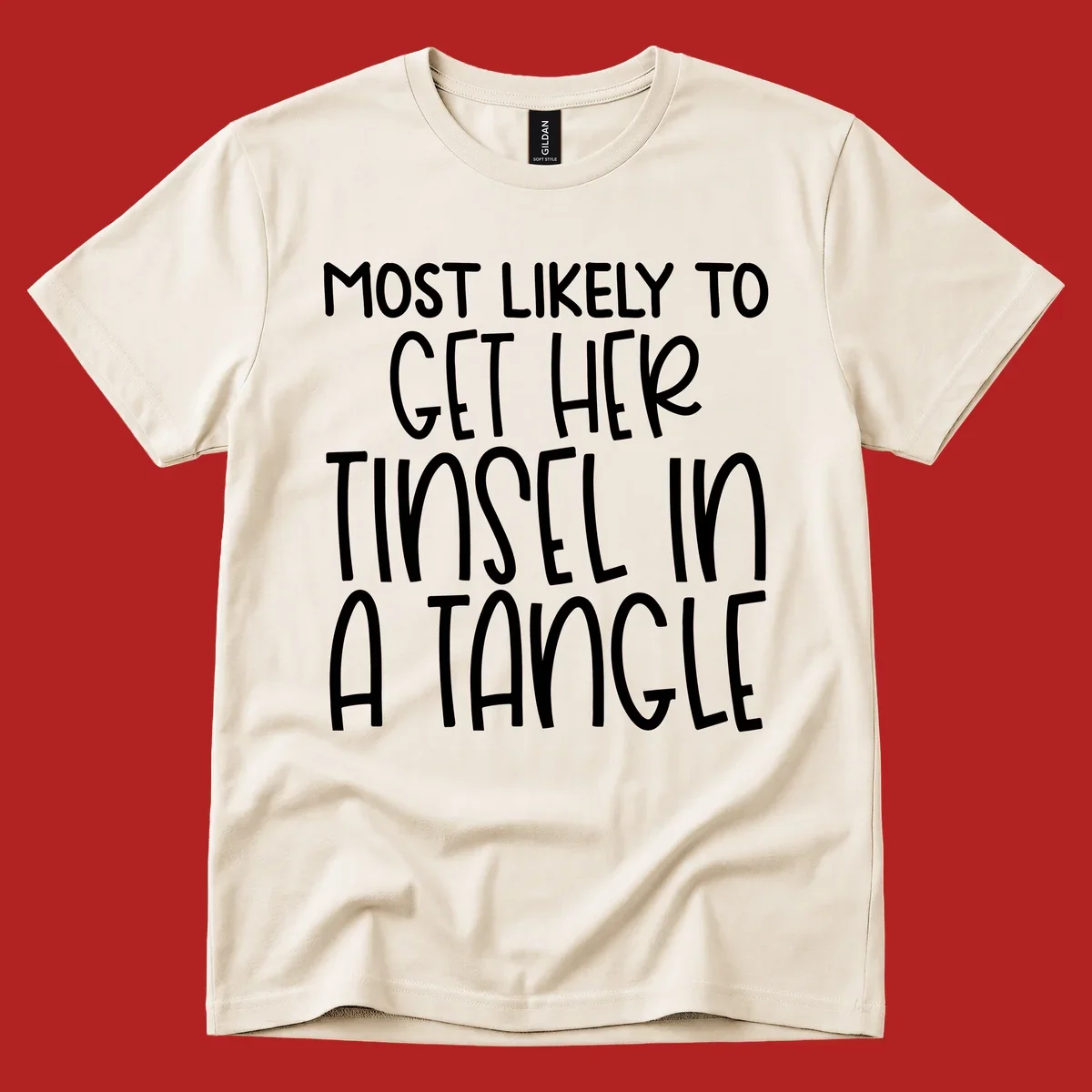 White text 'Most Likely To Get Her Tinsel In A Tangle' on a black background, holiday phrase.